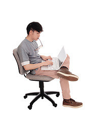 Image showing Korean man typing at his laptop.