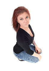 Image showing Surprised young woman crouching on floor.