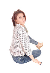 Image showing Serious looking woman sitting on floor.