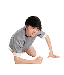 Image showing Asian man kneeling on floor.