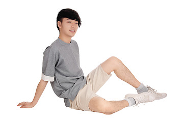 Image showing Asia teenager sitting on floor.