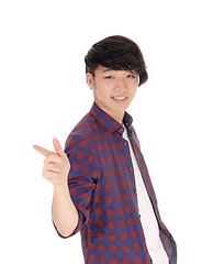 Image showing Asian teenager pointing finger.