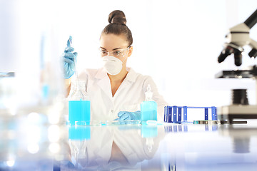 Image showing Research. Chemist examine the sample under a microscope.