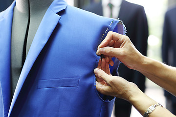 Image showing Men's tailoring, sewing jackets.