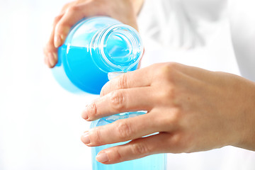 Image showing Chemist poured liquids in glass rulers