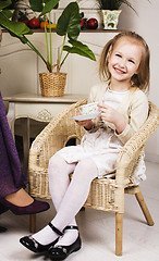 Image showing little cute blonde european girl playing at home interior, lifes