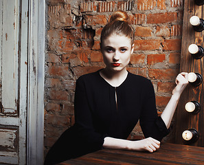 Image showing young stylish woman in make up room with mirror, diva actress before perfomance thinking art. loft interior