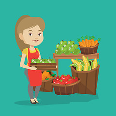 Image showing Supermarket worker with box full of apples.