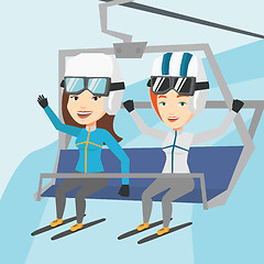 Image showing Two happy skiers using cableway at ski resort.
