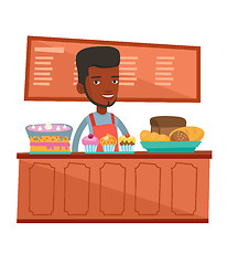 Image showing Worker standing behind the counter at the bakery.