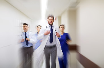 Image showing group of medics walking along hospital