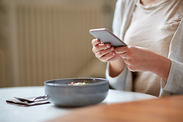 Image showing woman with smartphone photographing food at cafe