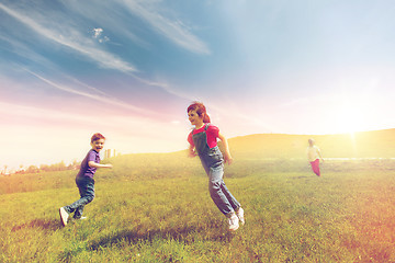 Image showing group of happy kids running outdoors