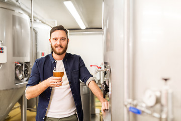 Image showing man drinking and testing craft beer at brewery