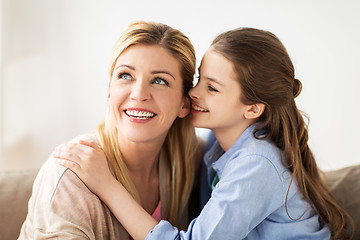 Image showing happy girl whispering secret to her mother at home