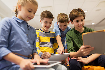 Image showing group of happy children with tablet pc at school
