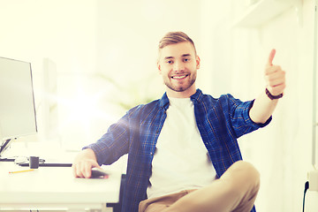 Image showing happy creative man with computer at office