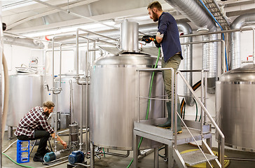 Image showing men working at craft beer brewery kettles