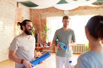 Image showing group of people with mats at yoga studio or gym