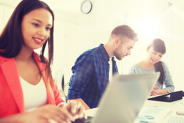 Image showing creative team with tablet pc and papers at office