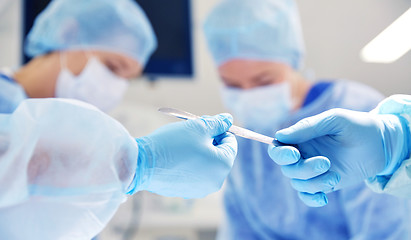 Image showing close up of hands with scalpel at operation