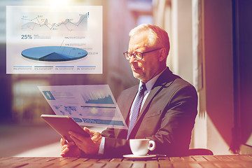 Image showing senior businessman with tablet pc drinking coffee