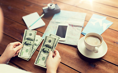 Image showing close up of traveler hands counting dollar money