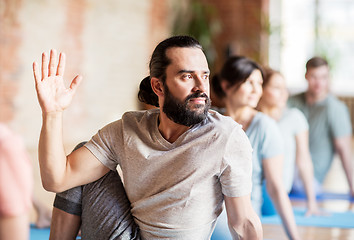 Image showing man with group of people doing yoga at studio