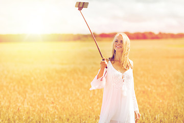 Image showing happy young woman taking selfie by smartphone