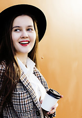 Image showing young pretty hipster girl student with coffee cup posing adorable smiling, lifestyle people concept outdoor 