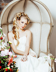 Image showing beauty young blond woman bride alone in luxury vintage interior with a lot of flowers 