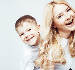 Image showing young modern blond curly mother with cute son together happy smiling family posing cheerful on white background, lifestyle people concept, sister and brother friends 