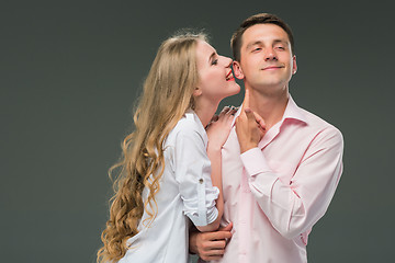 Image showing Portrait of a young couple standing against gray background