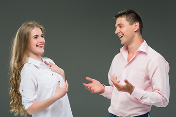 Image showing Portrait of a young couple standing against gray background