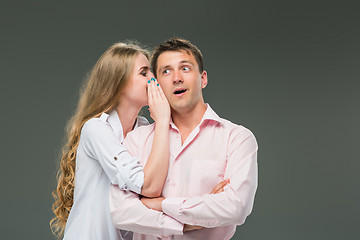 Image showing Portrait of a young couple standing against gray background