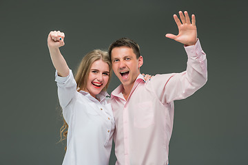 Image showing Portrait of a young couple standing against gray background