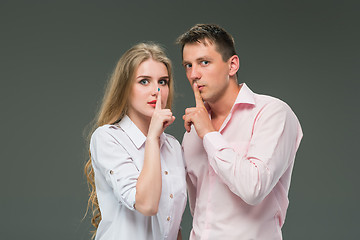 Image showing Portrait of a young couple standing against gray background