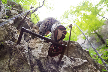 Image showing Woman climbing on the rocky route up the mountain.