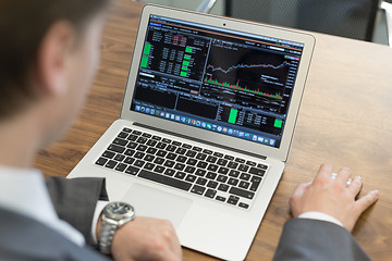 Image showing Young businessman working with laptop, man\'s hands on notebook computer.