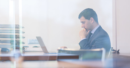 Image showing Elegant businessman analyzing data in modern office.