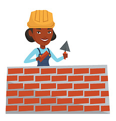 Image showing Bricklayer working with spatula and brick.