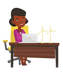 Image showing Woman working with model wind turbines.