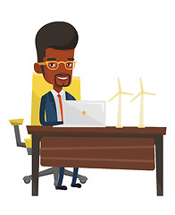 Image showing Man working with model wind turbines on the table.