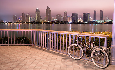 Image showing A bike is locked to the fence in Coronado with San Diego in the 