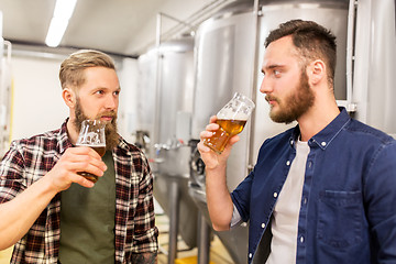 Image showing men drinking and testing craft beer at brewery