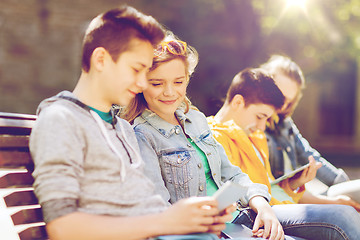 Image showing happy teenage friends with tablet pc outdoors