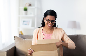 Image showing happy young indian woman with parcel box at home