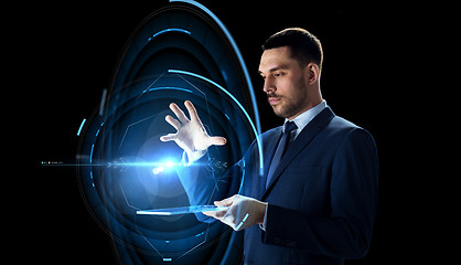 Image showing businessman with tablet pc and virtual projection