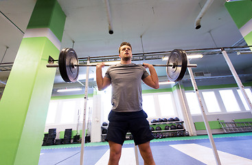 Image showing man doing exercise with barbell in gym