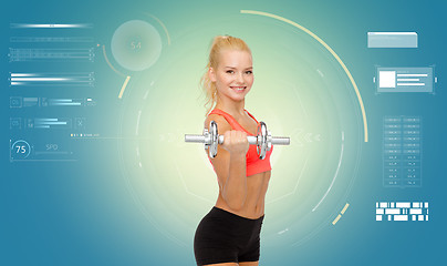 Image showing happy young sporty woman exercising with dumbbell